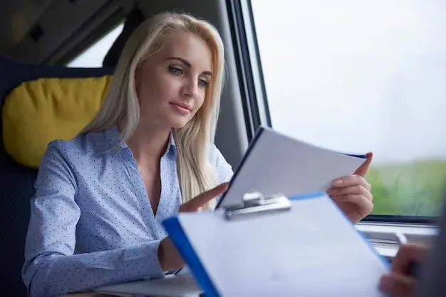 A woman reading her auto insurance files.webp