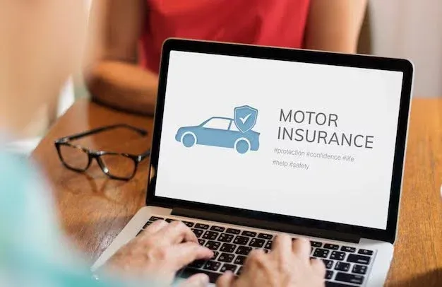 Driver comparing auto insurance rates online.webp