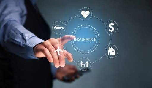 Insurance broker and agent comparing insurance products with a client.jpg