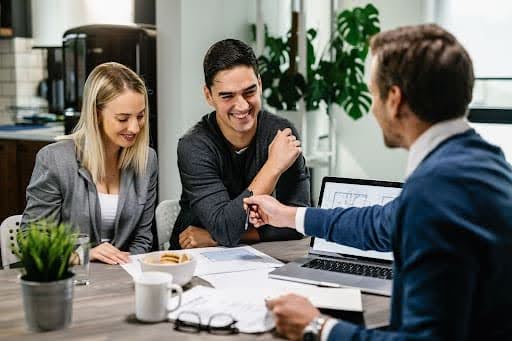 Insurance broker presenting multiple insurance policies to a customer.jpg