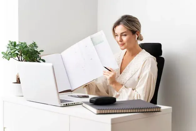 Woman looking at papers sitting in a chair.webp