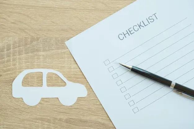auto insurance checklist sheet on desk.webp