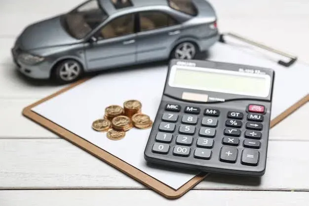 auto insurance papers on desk with coins and calculator.webp