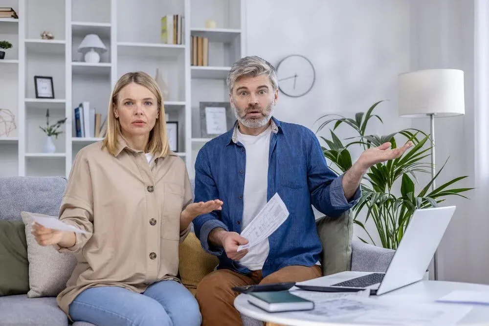 couple looking at the camera with a surprised expression.webp