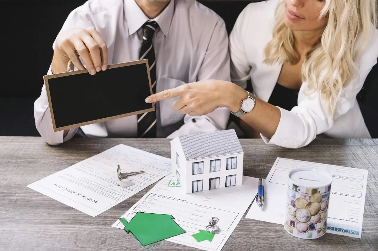 couple with a bunch of home insurance forms infornt of them.webp