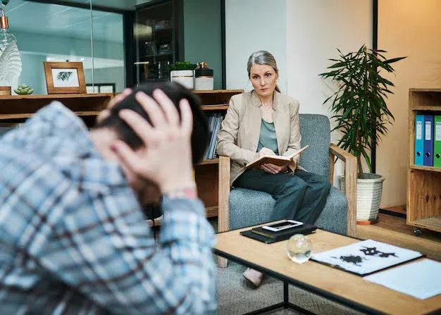 distressed man talking to his therapist.webp