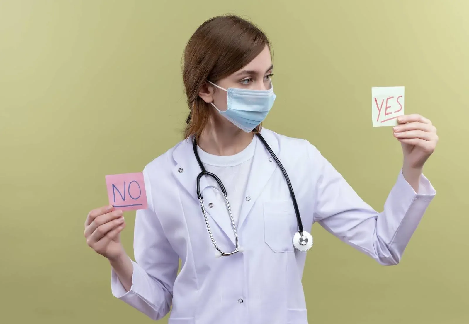 doctor holding up sticky notes saying yes or no.webp