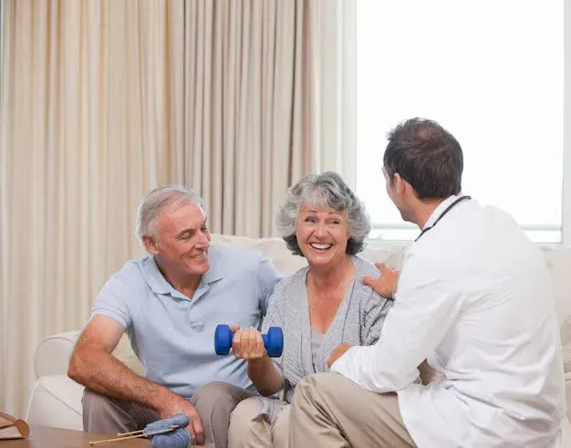 doctor showing an exercise to an elderly couple.webp