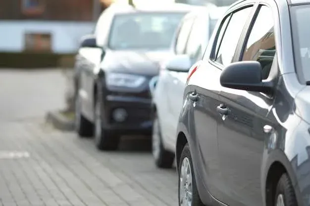 expensive cars parked in urban city.webp