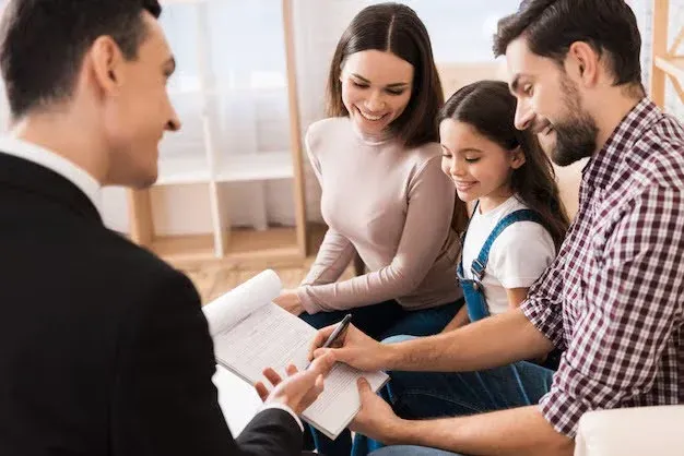family signing health insurance document.webp