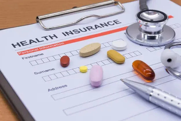 health insurance form with some pills on it.webp