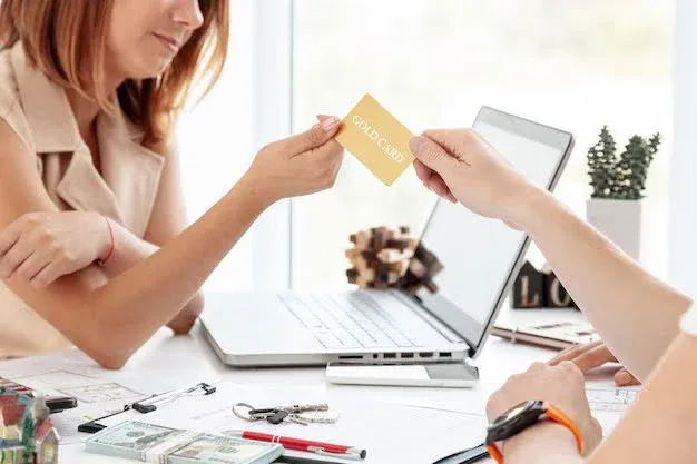 insurance broker handing out credit card.webp