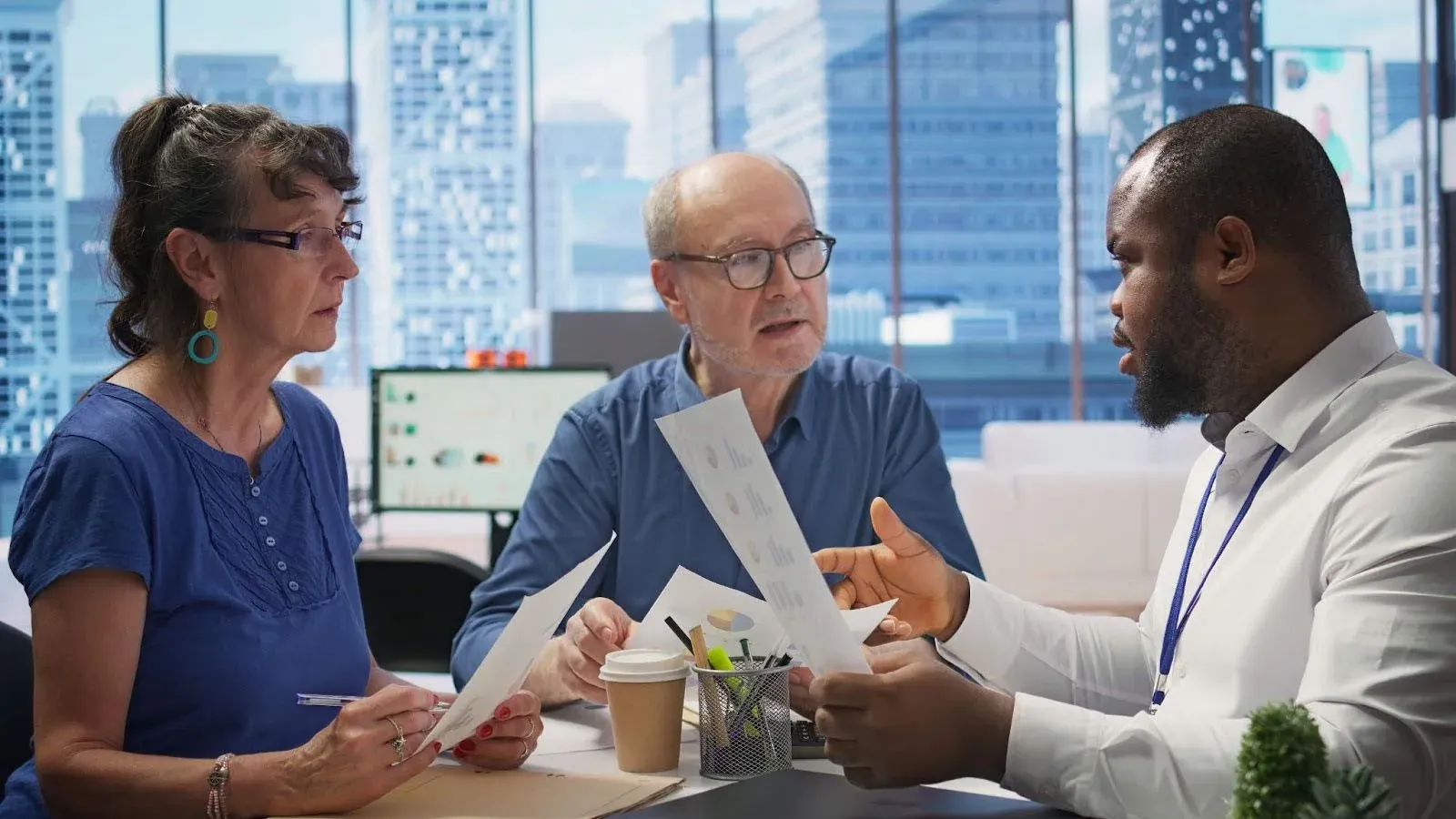 old couple discussing long term insurance plans with a broker.webp