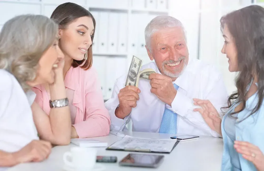 old man looking at his family and counting cash.webp