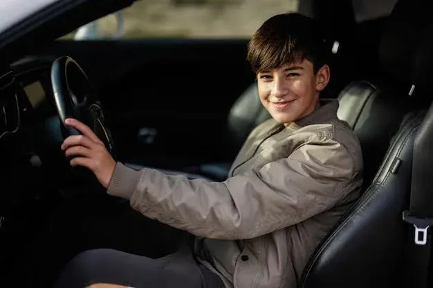 teenage boy sitting in driving seat.webp