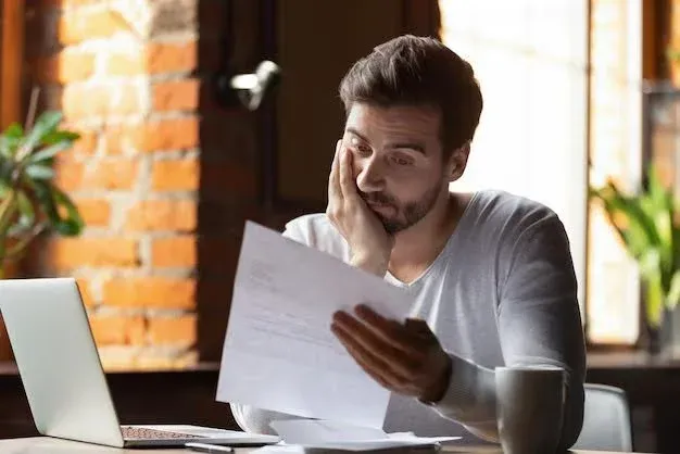 worried man reviewing an auto insurance bill.webp